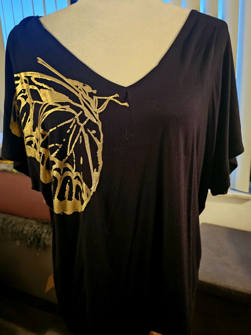 Discreet Black V-Neck Tee with Gold Butterfly Accent